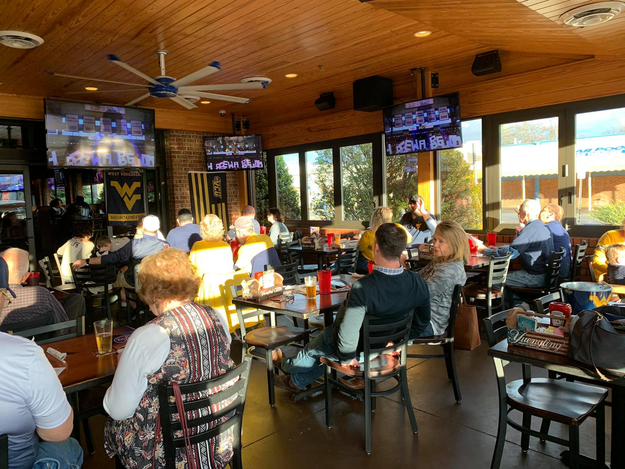 WVU fans celebrating at alumni gathering